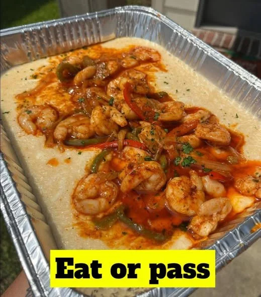Delicious Cajun shrimp and grits served in a bowl, garnished with herbs.