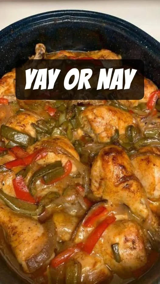 Delicious slow-cooked chicken with onions and peppers in a rustic dish