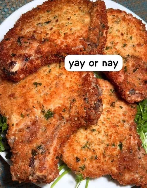 Delicious Parmesan Baked Pork Chops served with herbs and spices