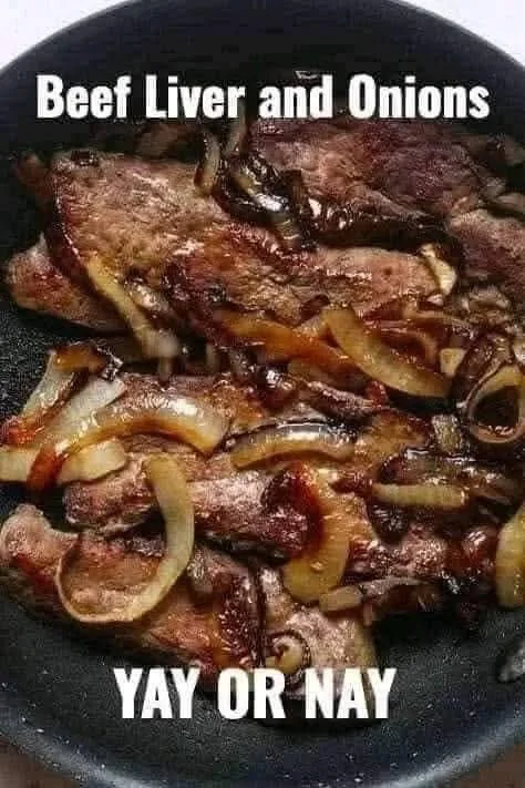 Plate of beef liver cooked with onions, garnished for a nutritious meal.