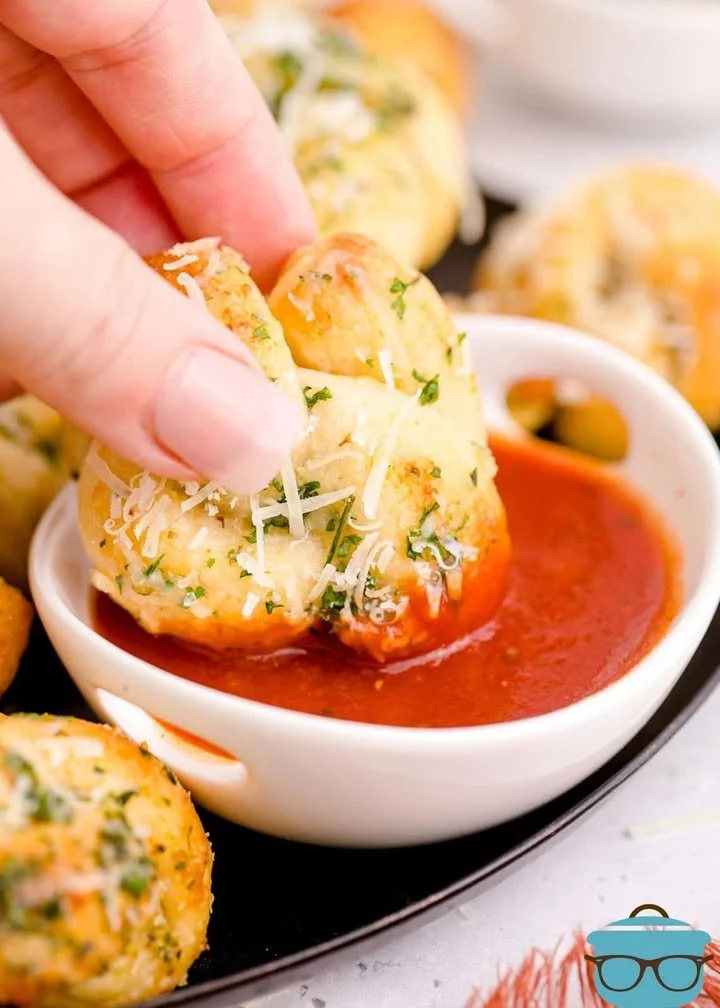 Freshly baked easy garlic knots coated in herbs and garlic butter