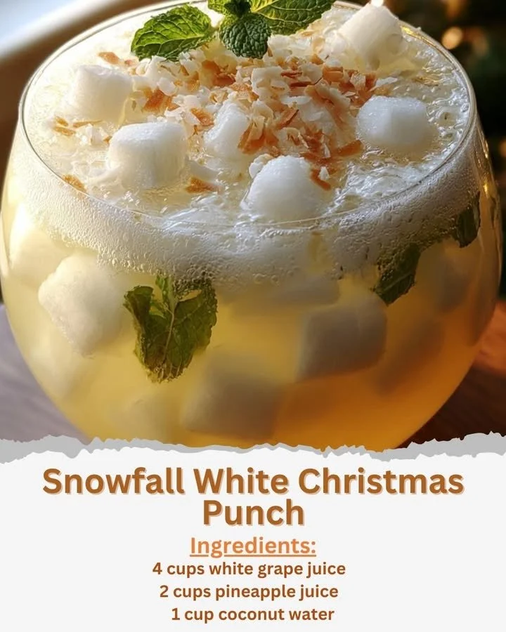 Snowfall White Christmas Punch in a festive glass with holiday decor