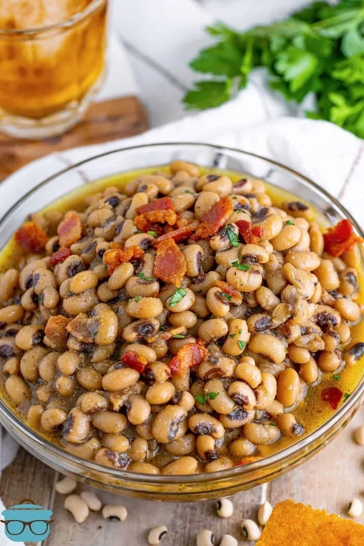 A bowl of Southern Black Eyed Peas garnished with herbs.